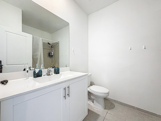 bathroom featuring toilet, vanity, tile patterned floors, and curtained shower