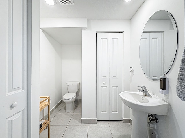 bathroom with tile patterned floors and toilet