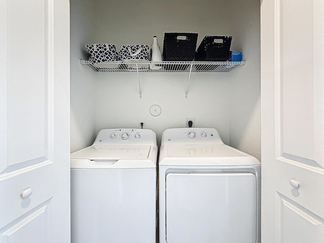 washroom with washing machine and clothes dryer