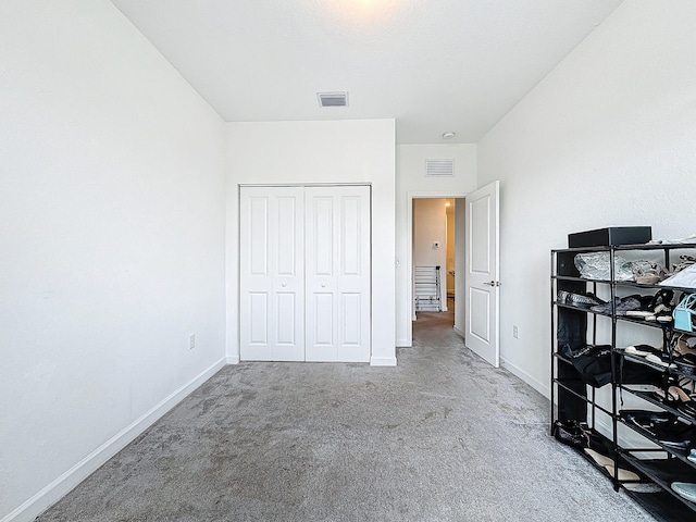 carpeted bedroom featuring a closet