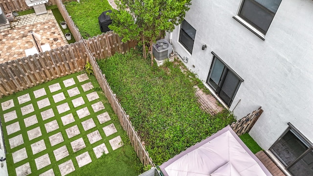 view of yard featuring central air condition unit and a patio