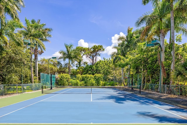 view of tennis court featuring basketball hoop