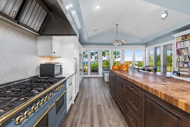 kitchen with butcher block counters, stainless steel range, french doors, dark hardwood / wood-style flooring, and white cabinets