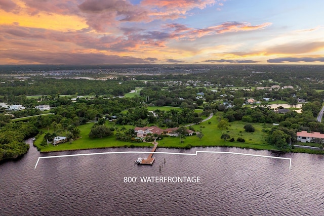 aerial view at dusk with a water view