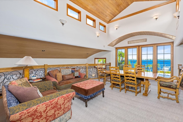 living room featuring carpet flooring, wooden ceiling, high vaulted ceiling, and a water view