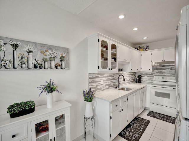 kitchen featuring sink, white cabinets, white appliances, and light tile patterned floors