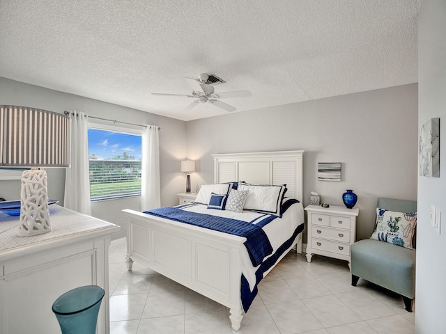 tiled bedroom featuring a textured ceiling and ceiling fan