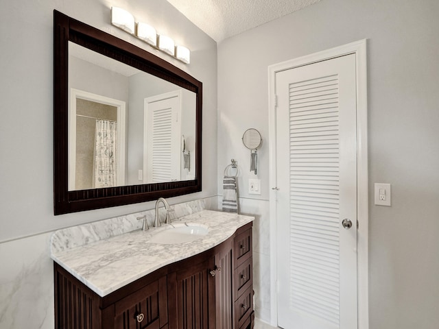 bathroom featuring vanity and a textured ceiling