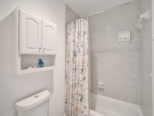 bathroom with shower / tub combo and toilet