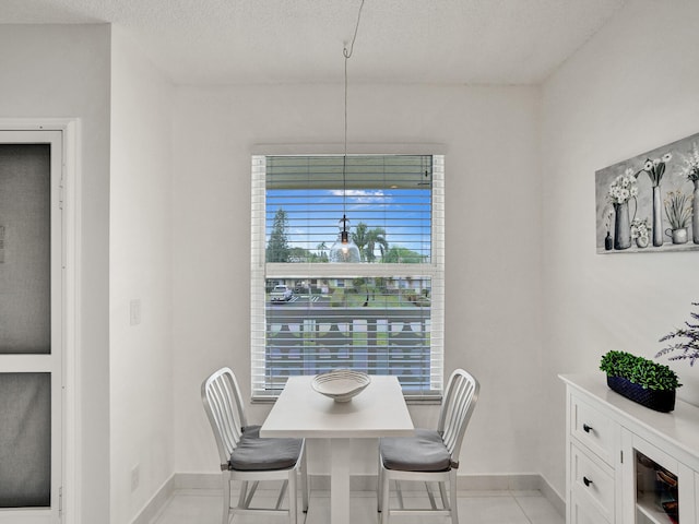 tiled dining room featuring a textured ceiling and wine cooler