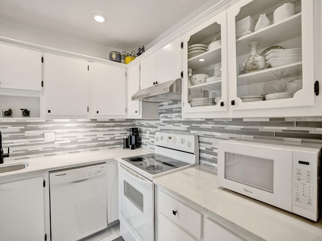 kitchen featuring white cabinetry, white appliances, and backsplash