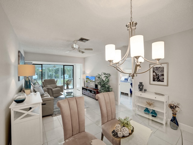 living room with light tile patterned floors, ceiling fan with notable chandelier, and a textured ceiling