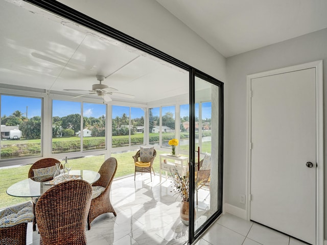 sunroom featuring ceiling fan