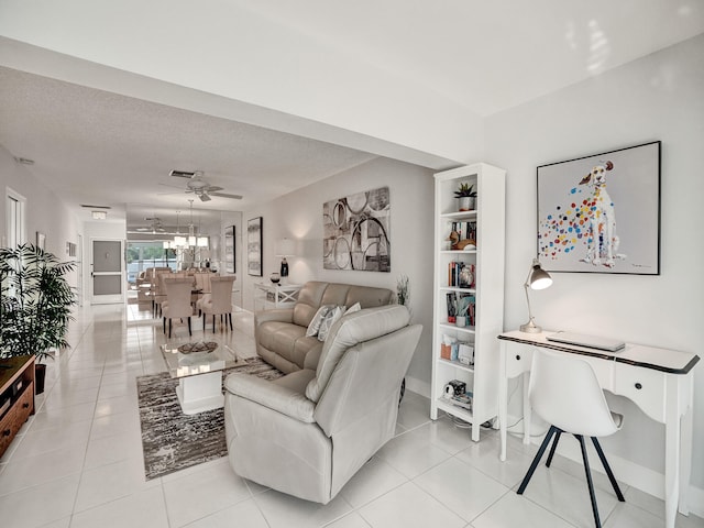 tiled living room featuring a textured ceiling and ceiling fan