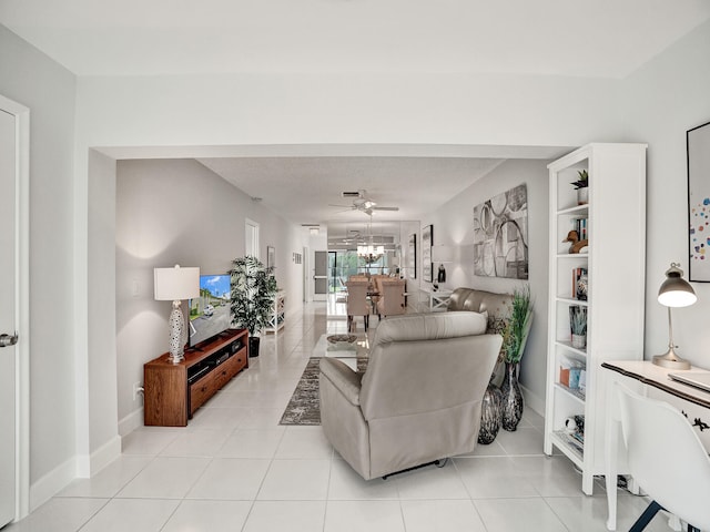 living room with light tile patterned floors and ceiling fan