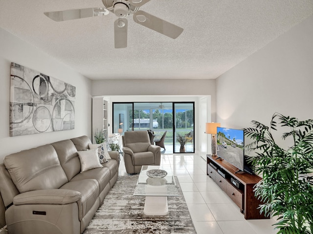 tiled living room with a textured ceiling and ceiling fan