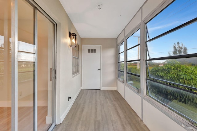 unfurnished sunroom with visible vents