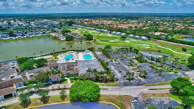 bird's eye view with a water view and view of golf course