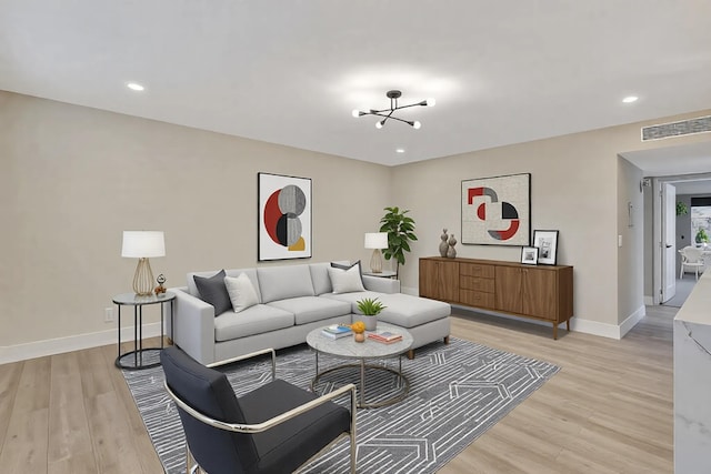 living area featuring light wood-type flooring, baseboards, and recessed lighting