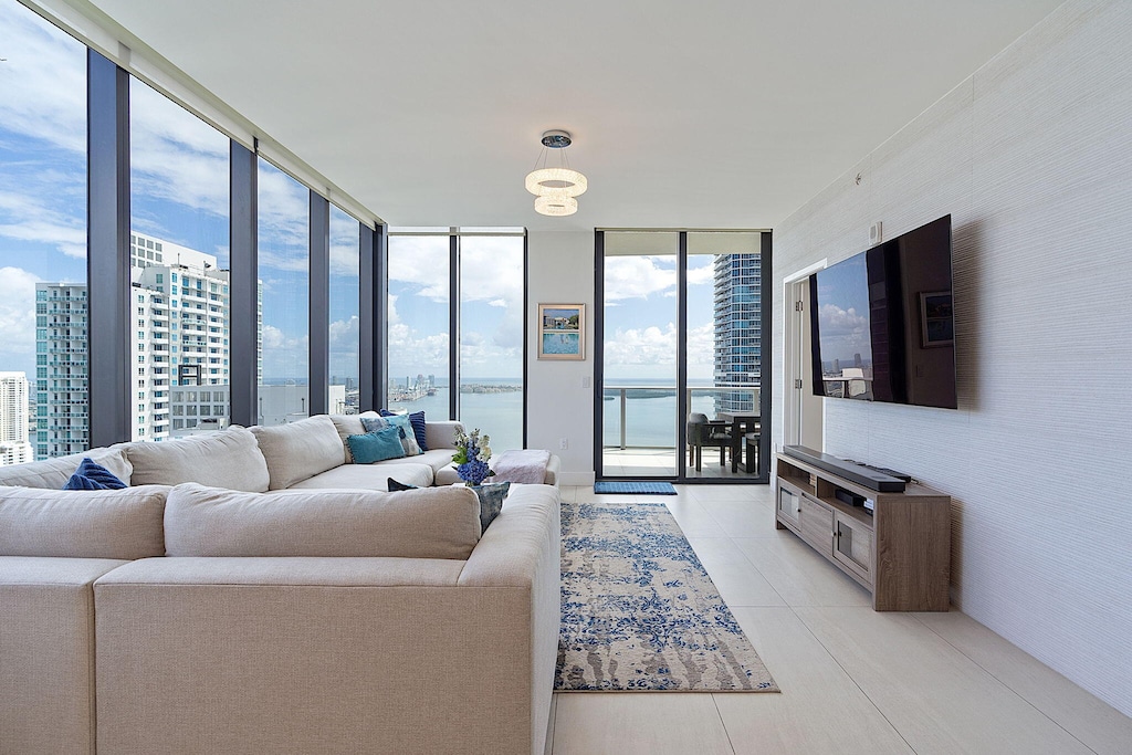 tiled living room with floor to ceiling windows