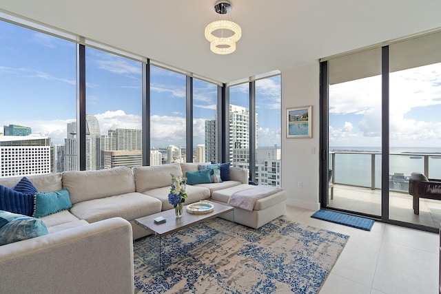 living room with a wall of windows and tile patterned flooring