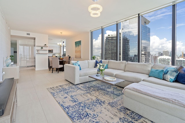 living room featuring light tile patterned flooring, floor to ceiling windows, and an inviting chandelier