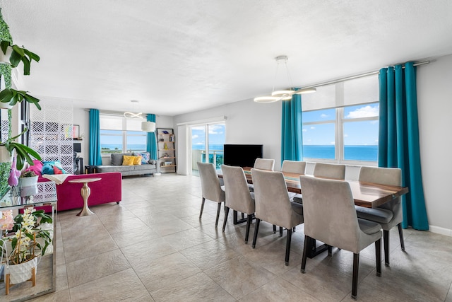 dining area featuring a textured ceiling and an inviting chandelier