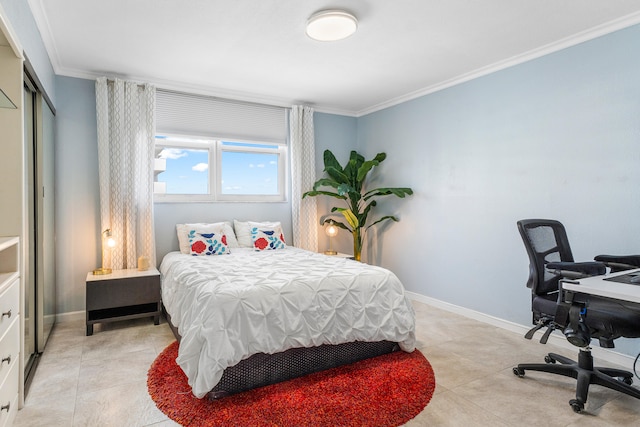 bedroom featuring a closet, ornamental molding, and light tile patterned flooring