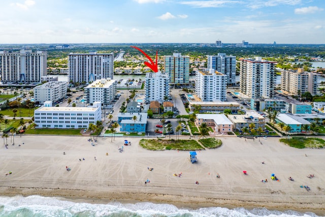 bird's eye view with a water view and a beach view