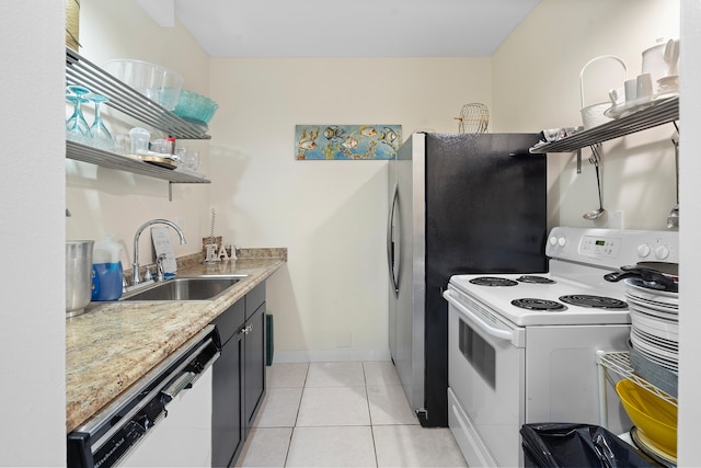 kitchen with sink, white electric stove, dishwashing machine, light stone counters, and light tile patterned floors