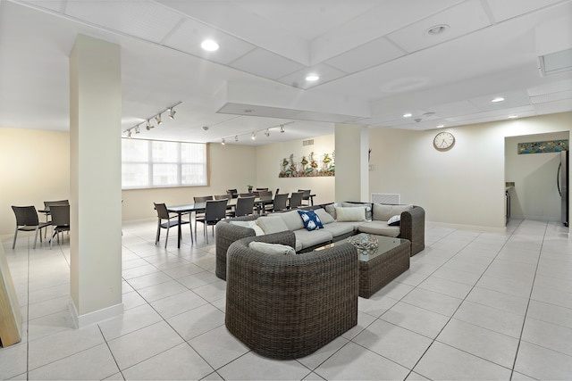 tiled living room featuring track lighting