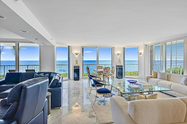 living room featuring plenty of natural light, expansive windows, and a water view