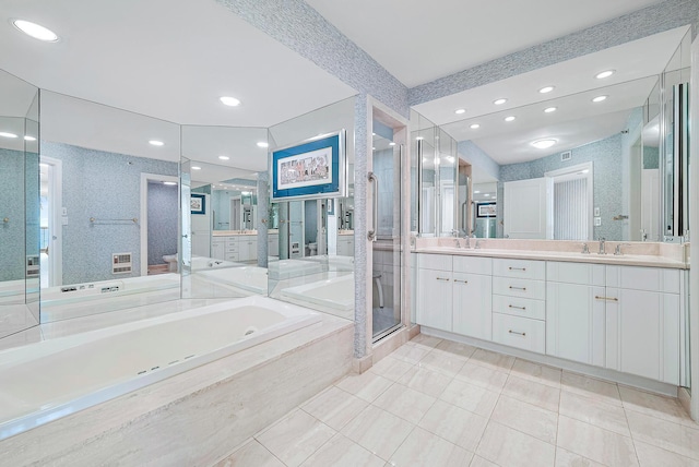 full bathroom featuring double vanity, a shower stall, a sink, and a bath