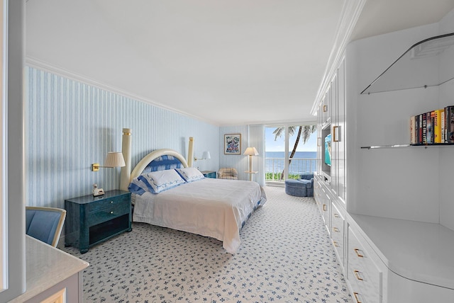 bedroom featuring a water view and crown molding