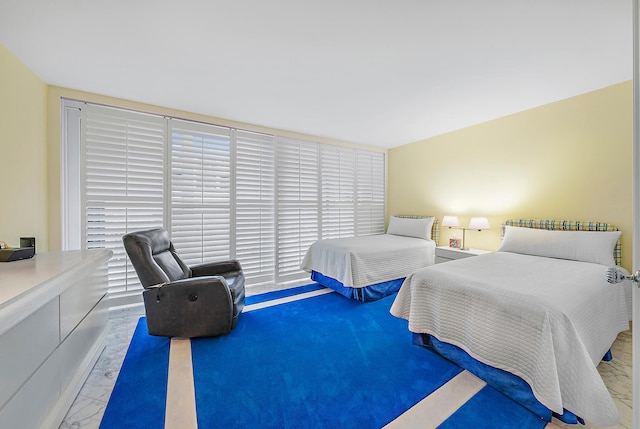 bedroom featuring marble finish floor