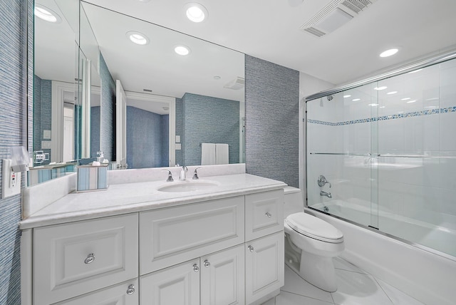 full bathroom featuring tile patterned floors, vanity, toilet, and shower / bath combination with glass door