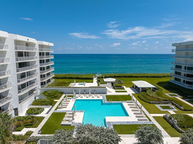 view of swimming pool with a water view