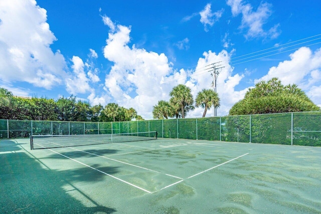 view of tennis court featuring fence