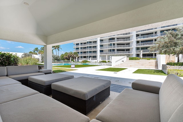 view of patio / terrace featuring an outdoor living space and a pool