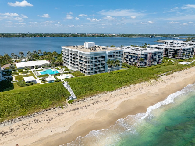 drone / aerial view featuring a beach view and a water view