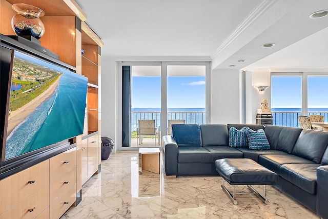 living room with plenty of natural light, a water view, and ornamental molding