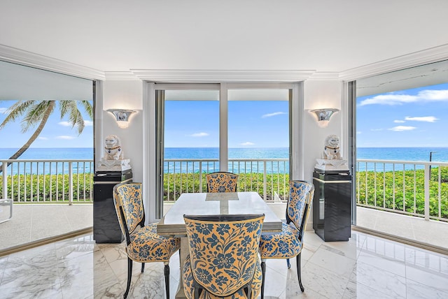 dining area featuring a water view, a wealth of natural light, and crown molding