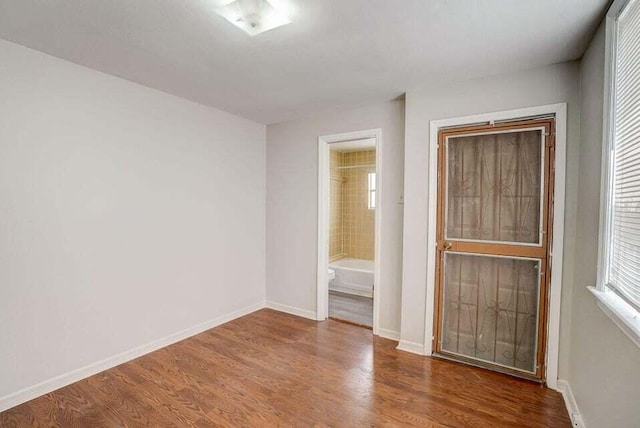 2511 W Abdella St, Tampa, FL 33607 - unfurnished bedroom featuring ensuite bathroom and wood-type flooring