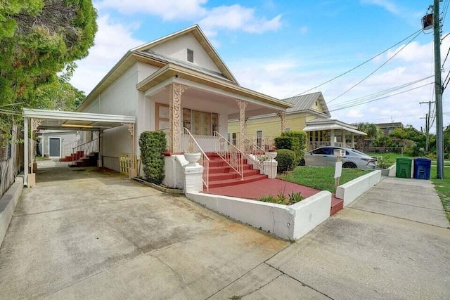 view of front of home featuring a carport and a porch