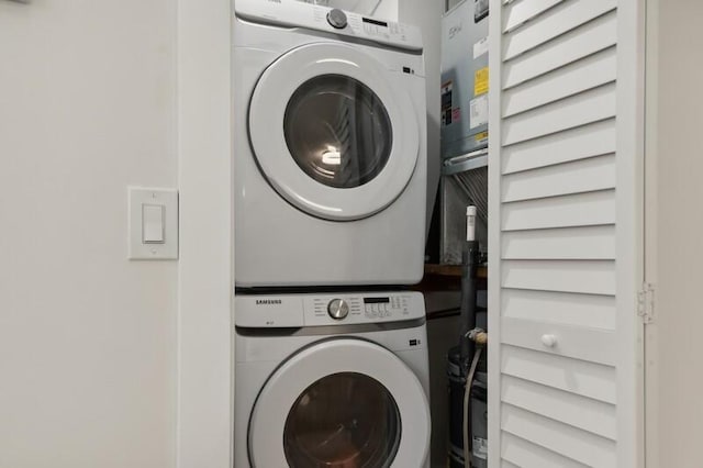 washroom featuring stacked washing maching and dryer