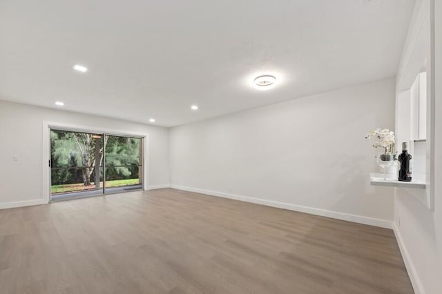 unfurnished room with wood-type flooring