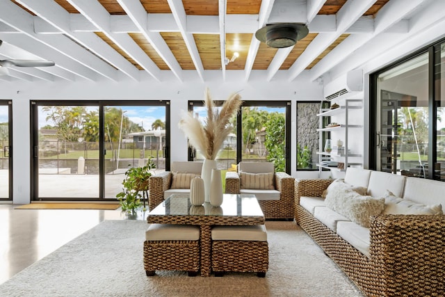 sunroom / solarium with wood ceiling, beam ceiling, a wall unit AC, and a wealth of natural light