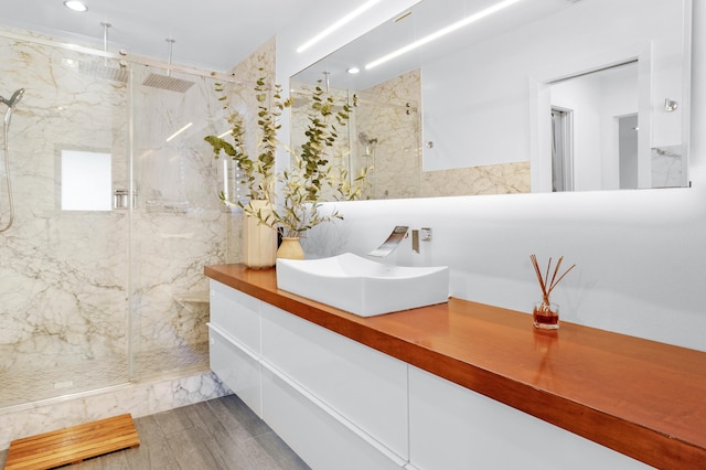 bathroom featuring vanity and a shower with shower door