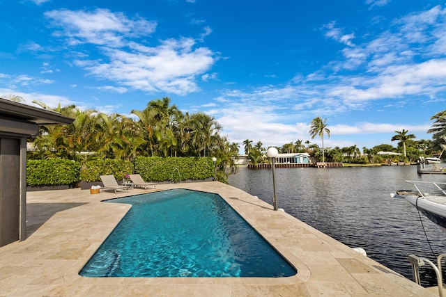 view of swimming pool with a water view and a patio area