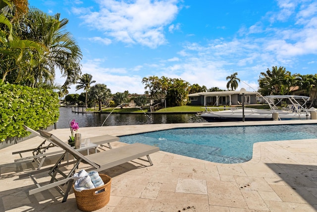 view of swimming pool featuring a water view and a patio area